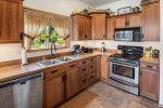 Kitchen with stainless steel appliances is fully appointed. 